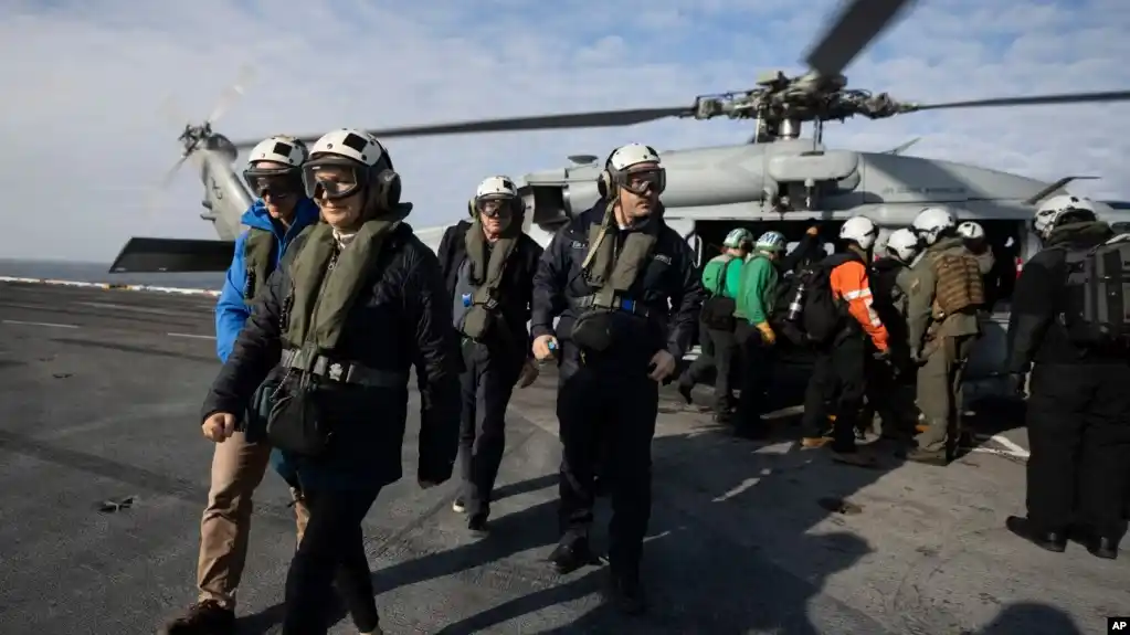 La canciller argentina, Diana Mondino, al frente, el ministro de Defensa, Luis Petri, y el embajador de EEUU en Argentina, Marc R. Stanley, llegan al portaviones USS George Washington frente a las costas de Argentina, durante ejercicios conjuntos, el 30 de mayo de 2024.