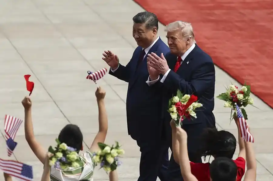 El presidente chino, Xi Jinping, y el presidente estadounidense, Donald Trump, interactúan con unos niños durante una ceremonia de bienvenida en Pekín. EFE