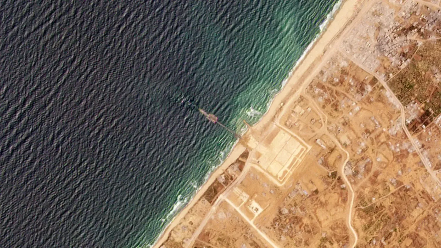 This satellite image from Planet Labs PBC shows a pier installed by the U.S. military in the Gaza Strip on May 16, 2024.