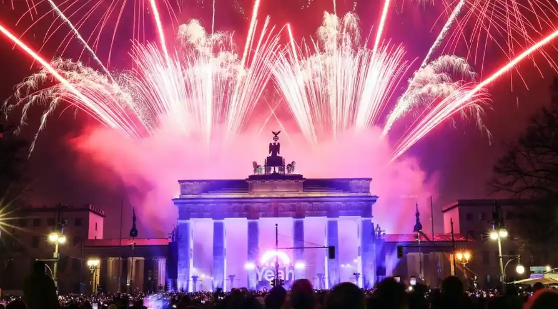 Fuegos artificiales iluminan el cielo sobre la Puerta de Brandeburgo. EFE