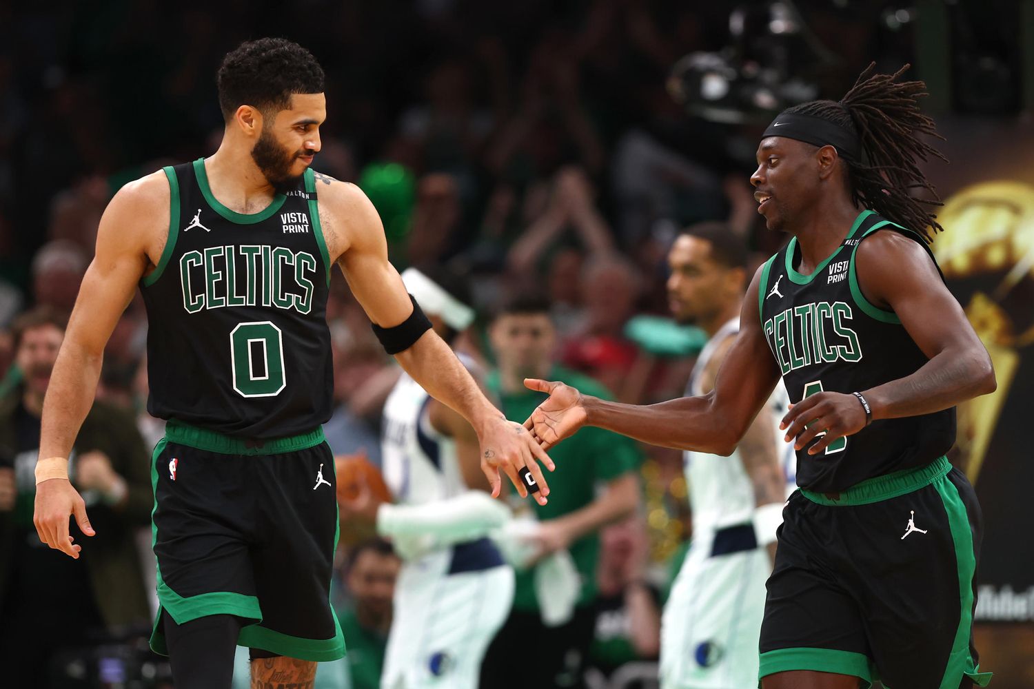 Jayson Tatum, left, ceded control of the Celtics' offense to Jrue Holiday in Sunday's Game 2 Celtics win.