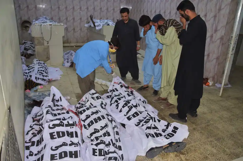 Un grupo de personas identifica a una de las víctimas de un atentado suicida, en una morgue de un hospital en Quetta, Pakistán, el 2 de septiembre de 2025. (AP Foto/Arshad Butt)