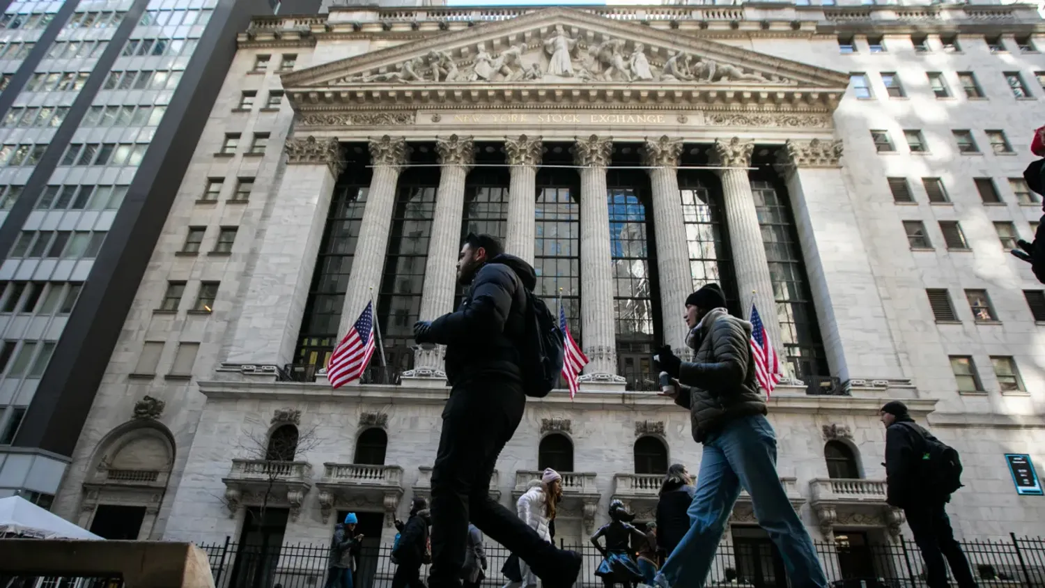 Pedestrians in front of the New York Stock Exchange in New York on Feb. 16, 2024