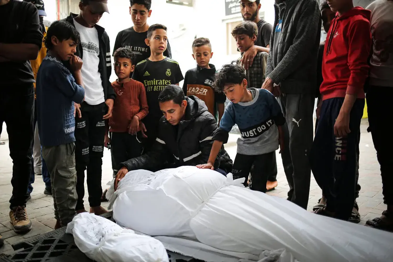 Mourning Palestinians killed overnight in an Israeli airstrike, in Rafah, southern Gaza Strip, on Saturday.