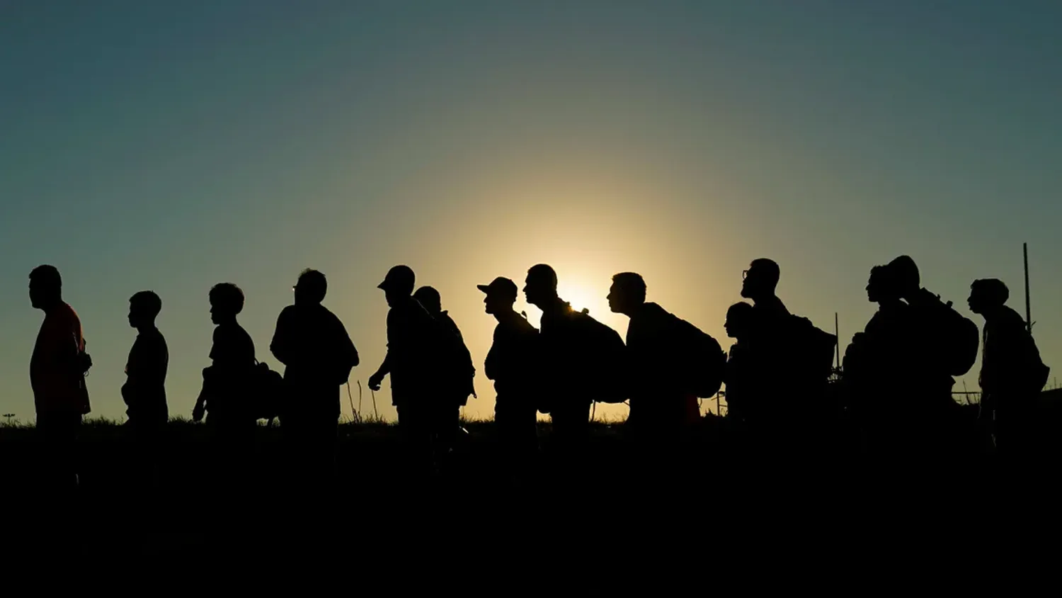 Migrants who crossed the Rio Grande and entered the US from Mexico are lined up for processing in September 2023 in Eagle Pass, Texas.