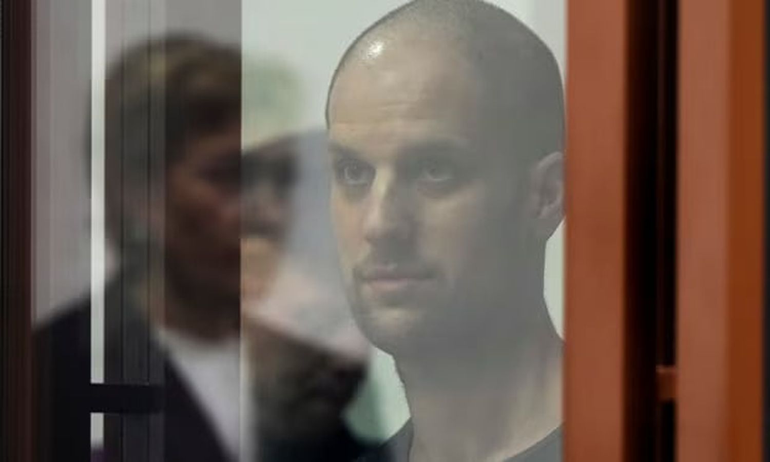 Evan Gershkovich listening to the verdict from the glass-covered defendants’ box at the court in Yekaterinburg