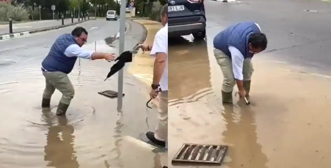 Utiliza un paraguas para desatascar una alcantarilla desbordada.