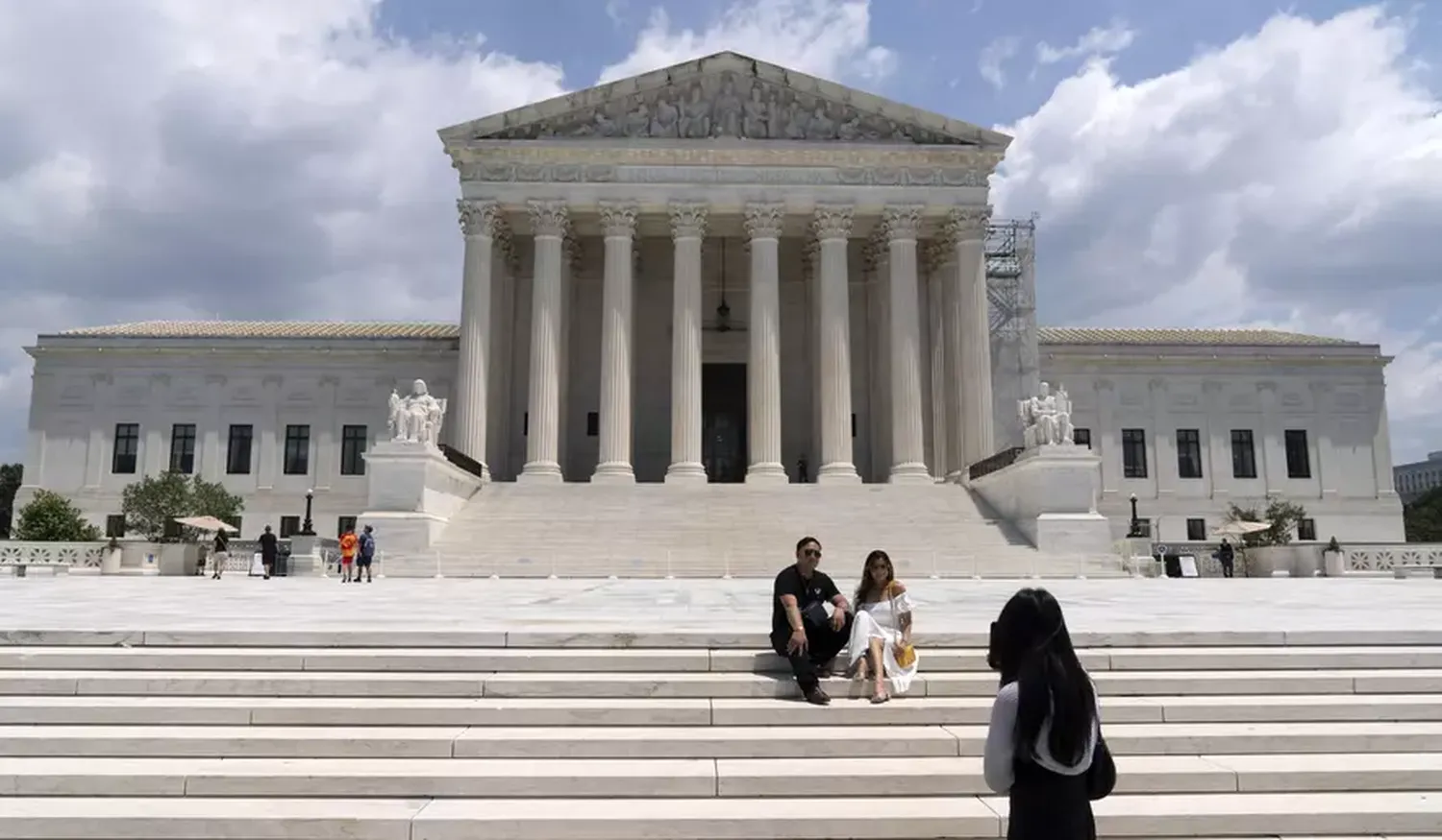 isitors pose for photographs outside the U.S. Supreme Court Tuesday, June 18, 2024, in Washington.