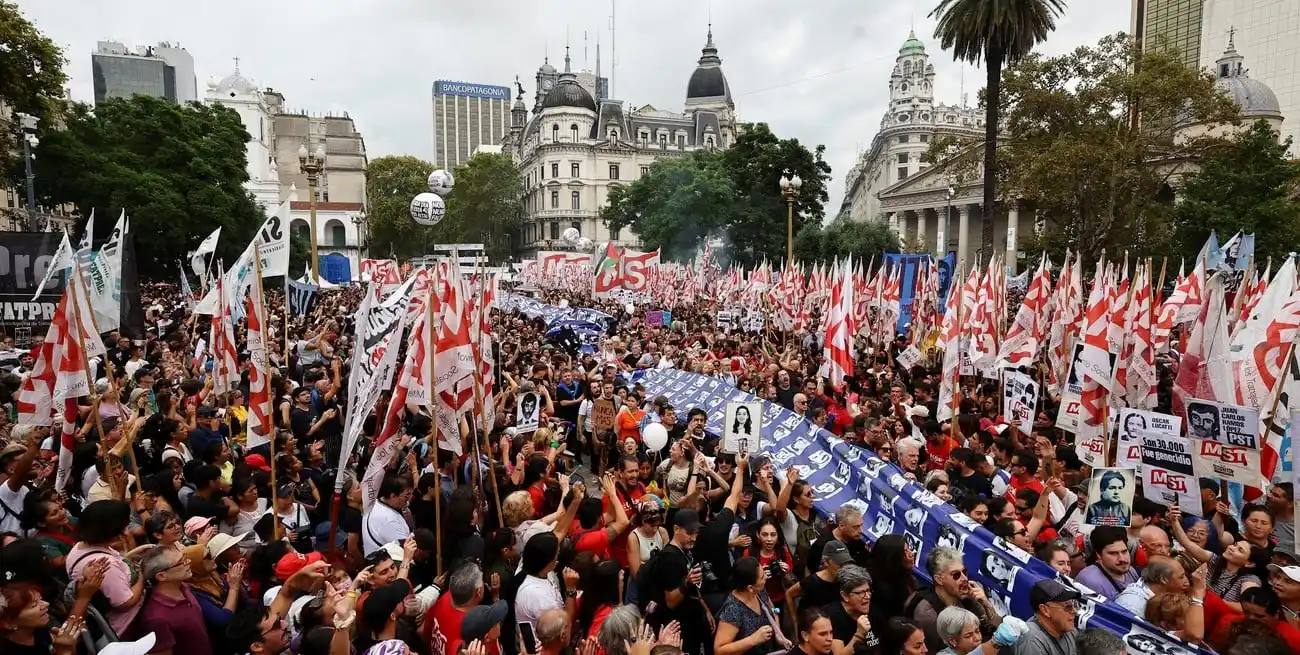 Cargando una bandera con imágenes de desaparecidos, miles de manifestantes se congregaron en la Plaza de Mayo en Buenos Aires a 49 años del golpe de 1976. Foto: REUTERS / Agustin Marcarian.