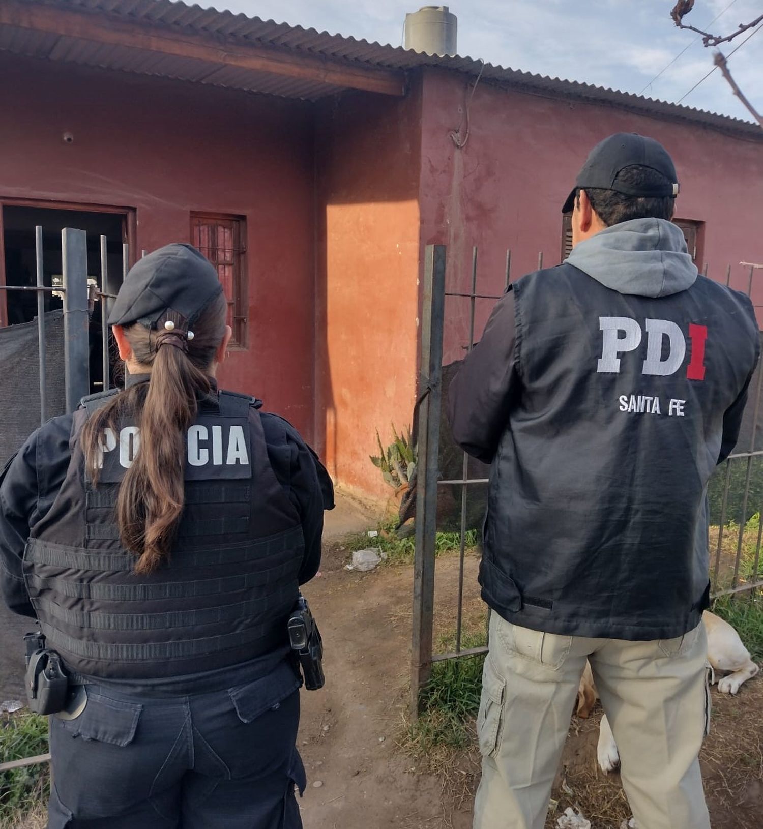 Personal policial frente al domicilio allanado.