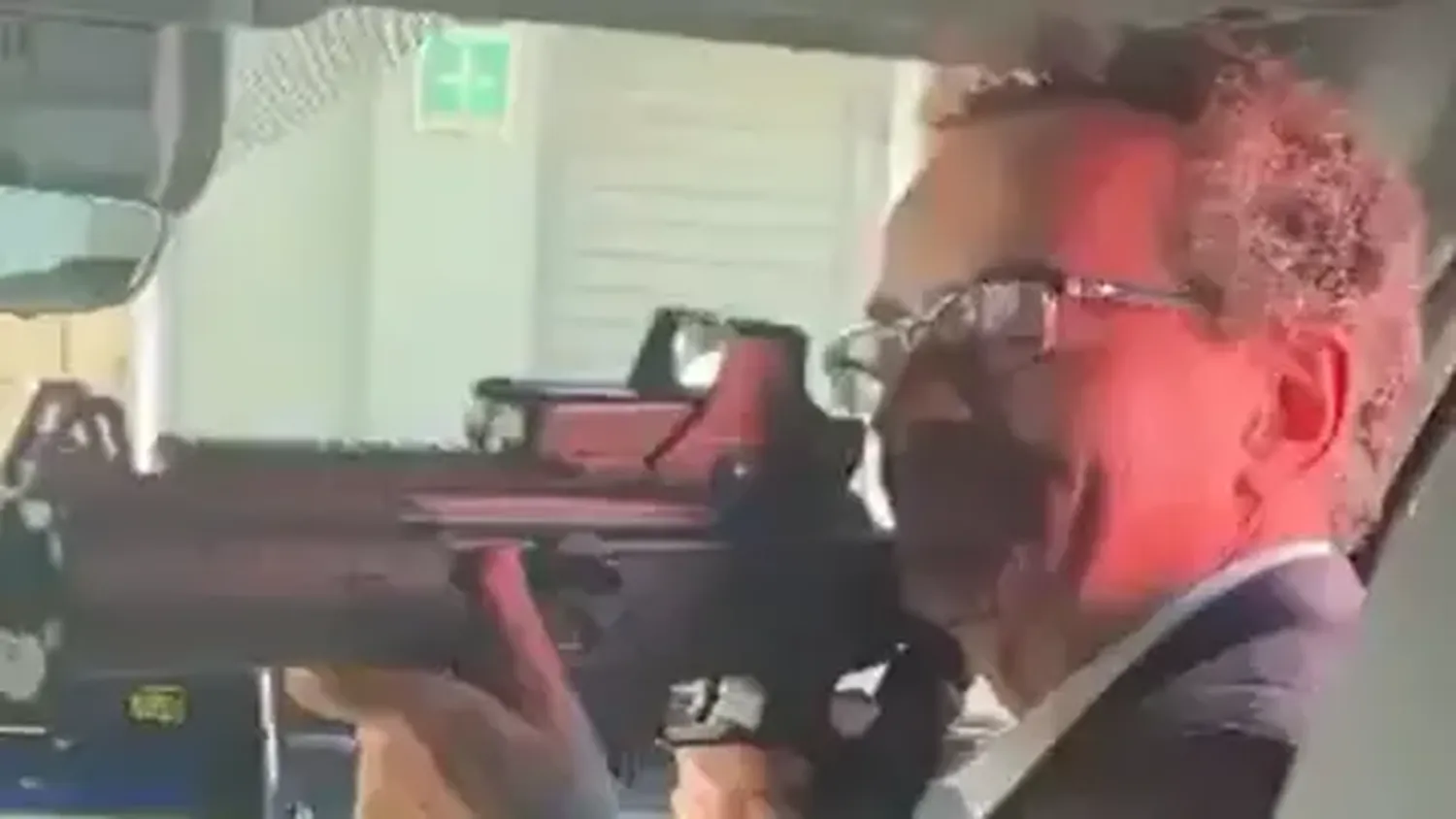 Former British ambassador to Mexico, Jon Benjamin, points a semi-automatic weapon at a Mexican staff member.