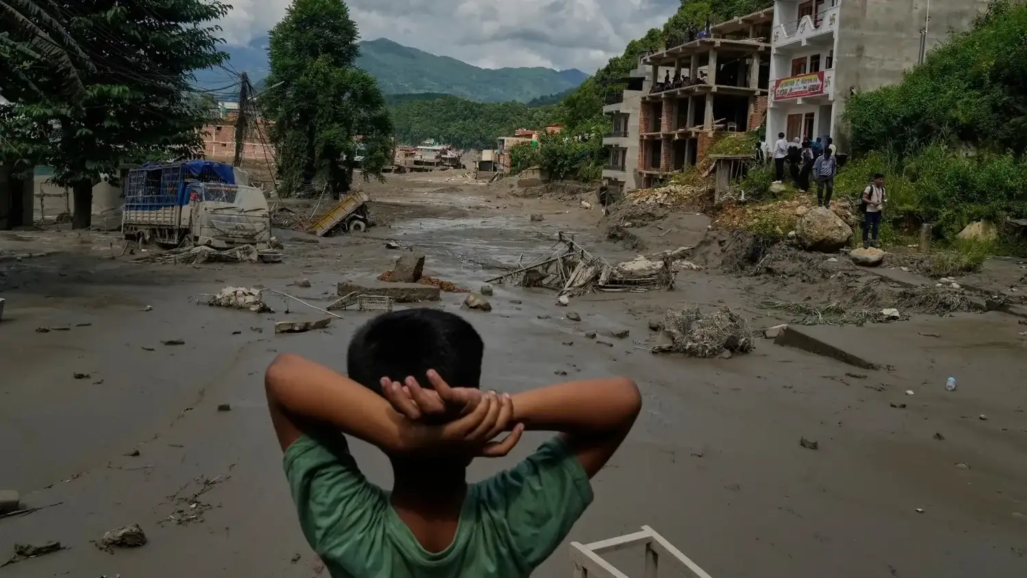 Sentado frente al paisaje arrasado, un niño contempla la magnitud de la destrucción provocada por la violenta crecida del río Trishuli en Nuwakot