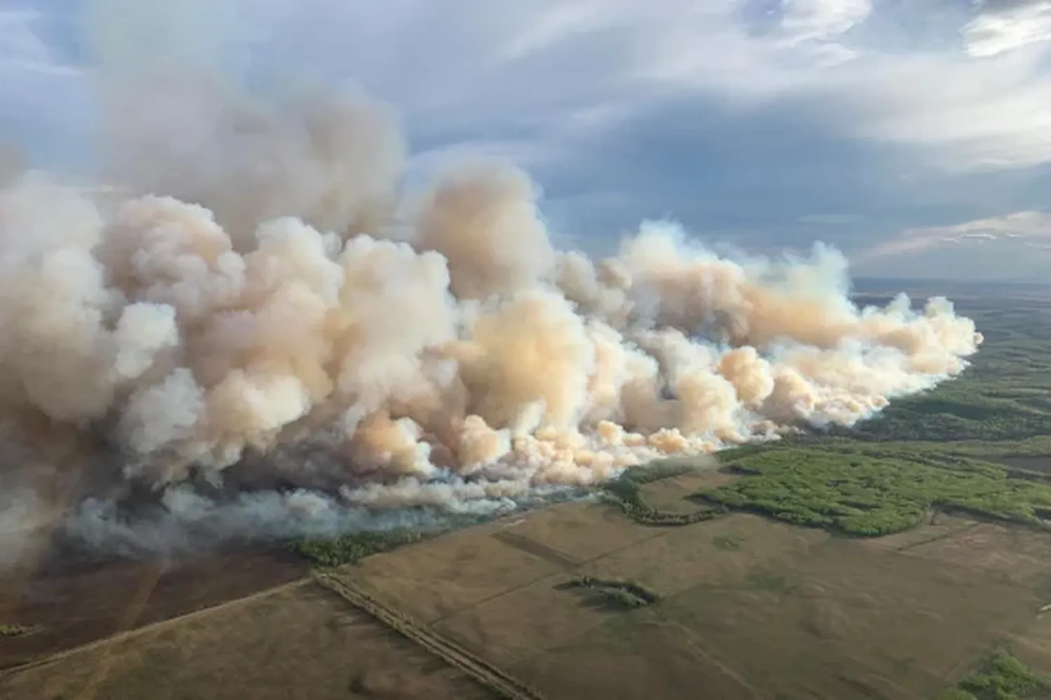 Smoke from wildfires burning in the Grande prairie forest area, east of the town of Teepee Creek, in Alberta, Canada