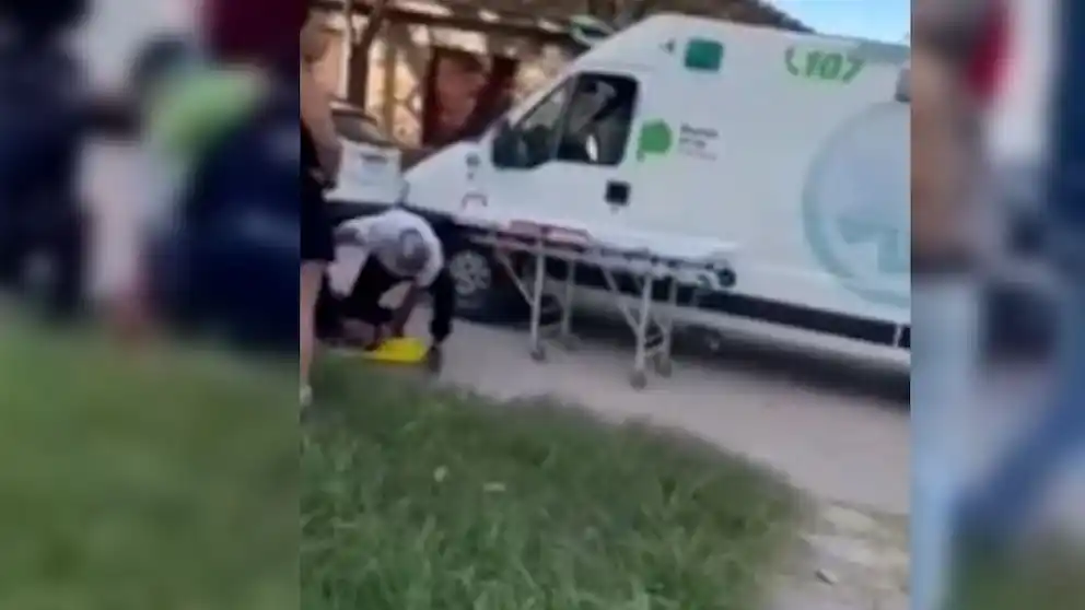 El hombre de remera blanca mientras golpea al joven de 15 años