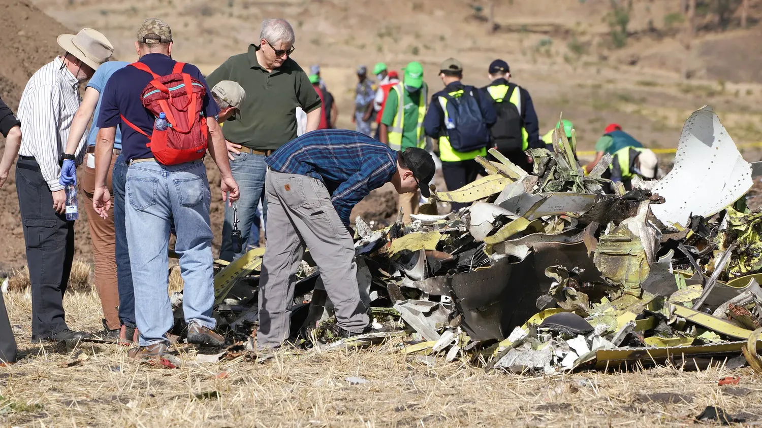 NTSB investigators look over debris at the crash site of Ethiopian Airlines Flight 302 on March 12, 2019, in Bishoftu, Ethiopia.