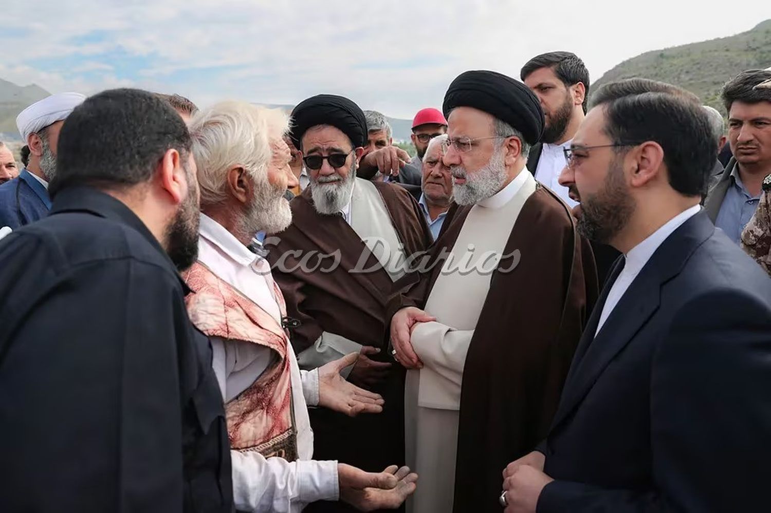 Raisi conversando con los residentes de la aldea de Kalalah, antes de subirse al helicóptero