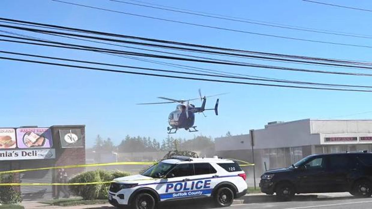 An emergency helicopter lands near the scene of a deadly crash in Deer Park, New York, on June 28, 2024