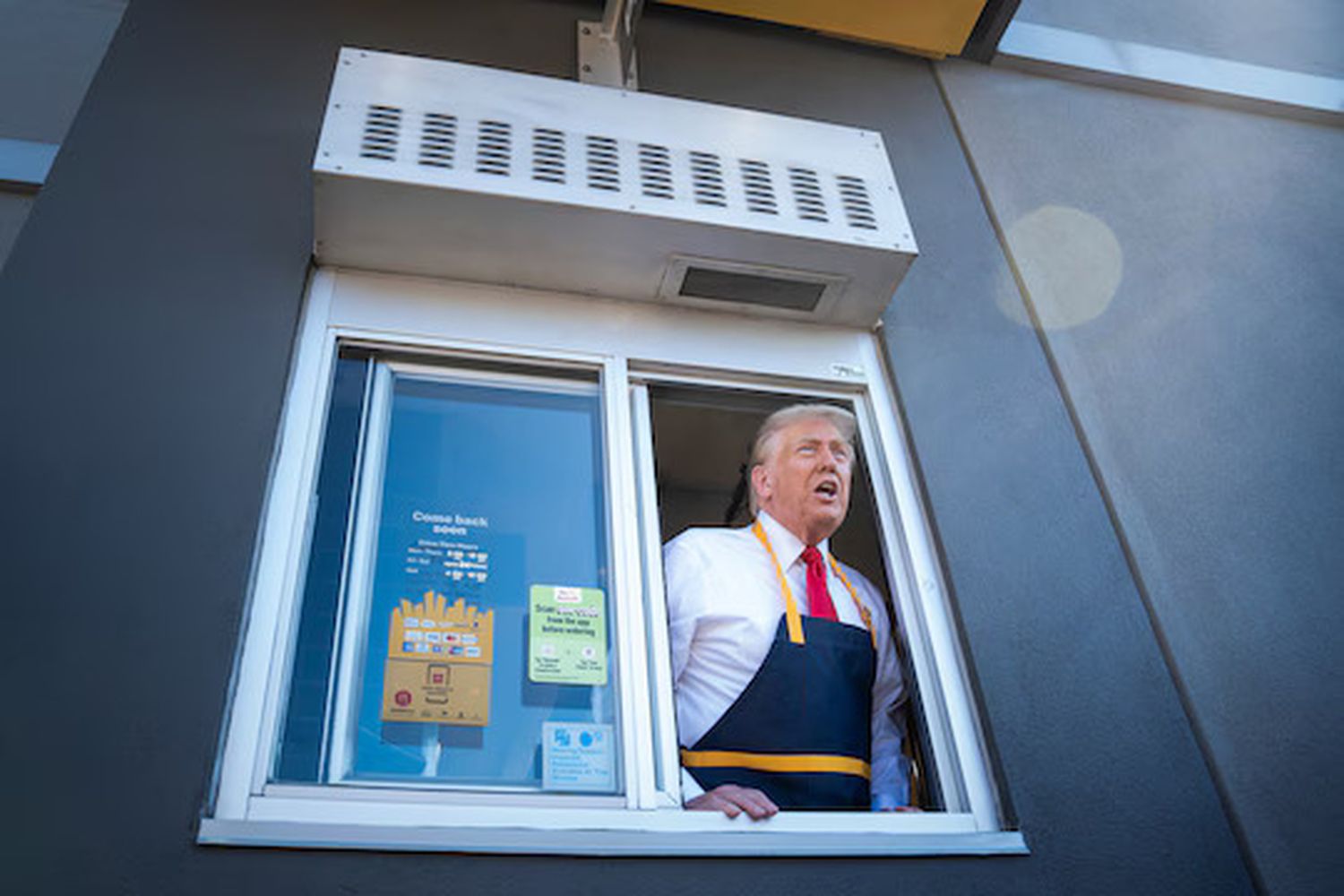 Donald Trump speaks to reporters through a drive-through a window at a McDonald's in Feasterville-Trevose, Pa., on Sunday