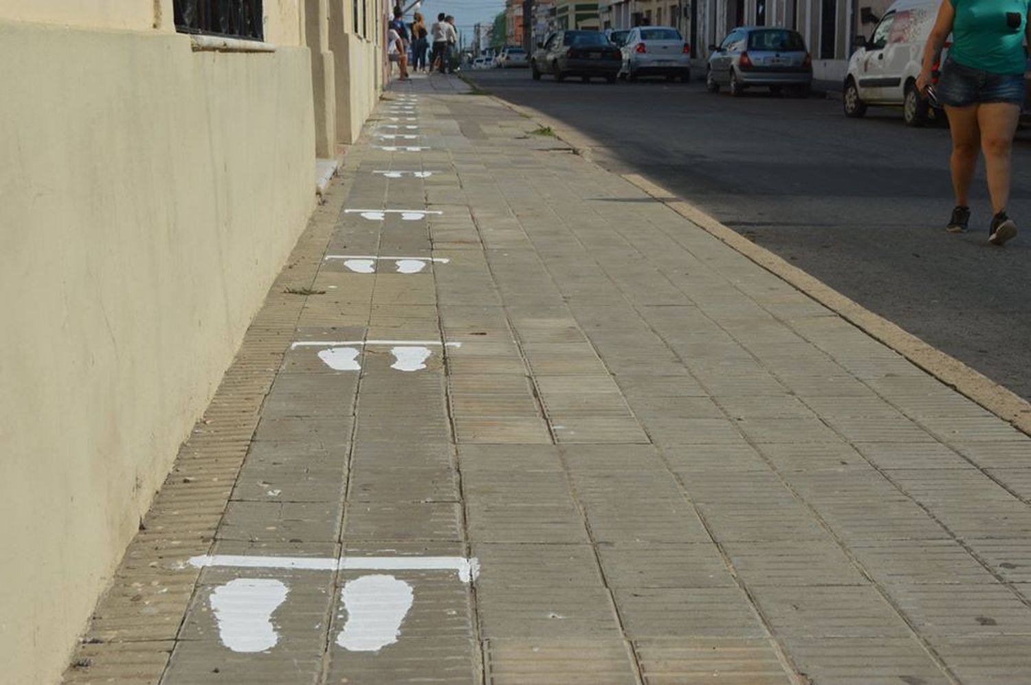 Pintan veredas para mantener distancia de las personas en las filas