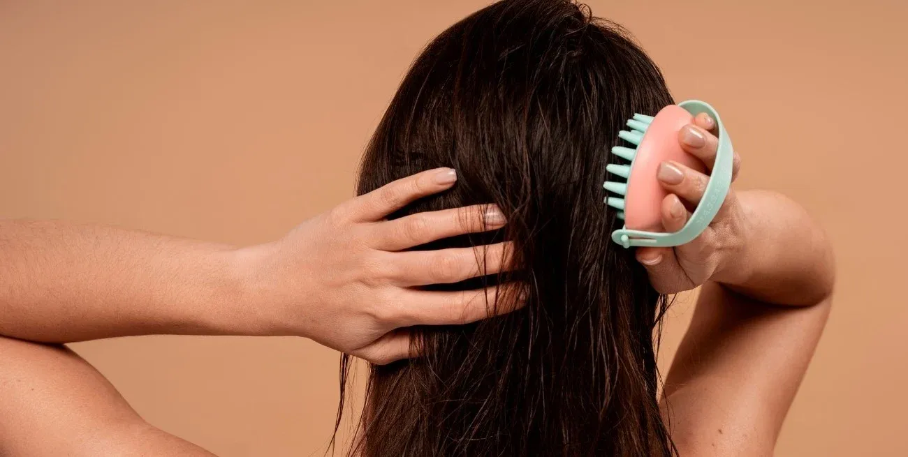 Aplicando movimientos circulares en el cuero cabelludo para estimular la circulación.