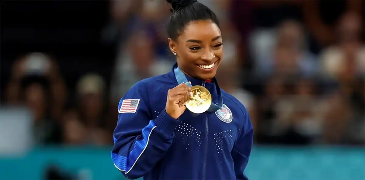 Simone Biles muestra la medalla dorada, la tercera que obtiene en estos Juegos. (EFE)