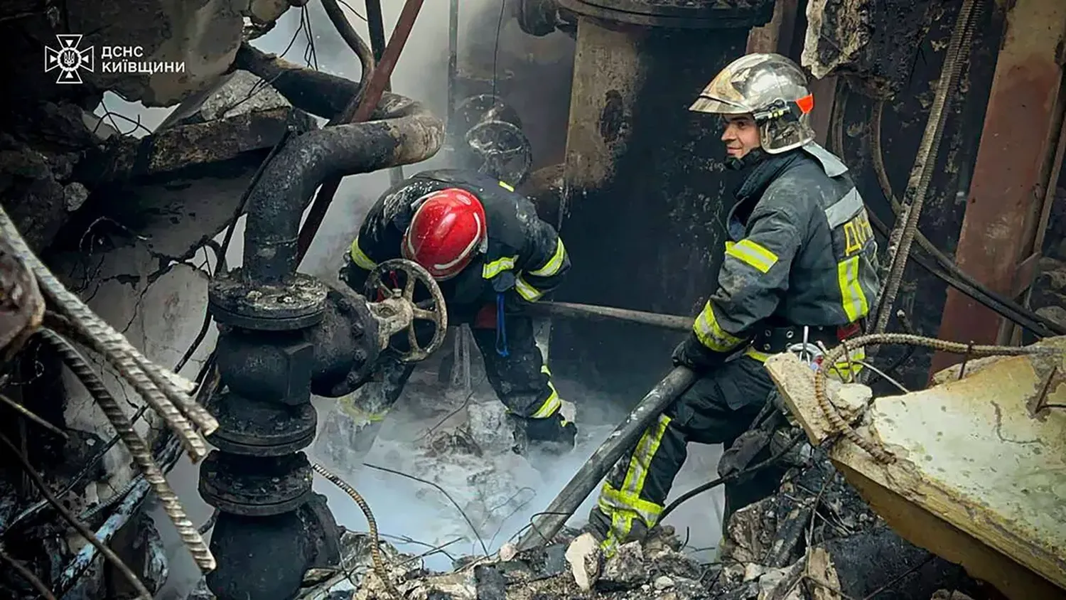 Emergency workers work to put out a fire after a Russian attack on the Trypilska thermal power plant in Ukrainka, Kyiv region, Ukraine