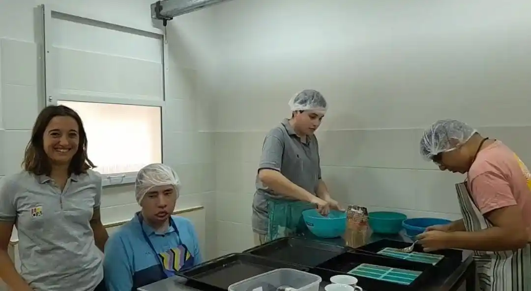 Magdalena -coordinadora del taller- con los jóvenes en la elaboración de alimentos saludables, otro de los emprendimientos del centro. Foto: Gentileza.