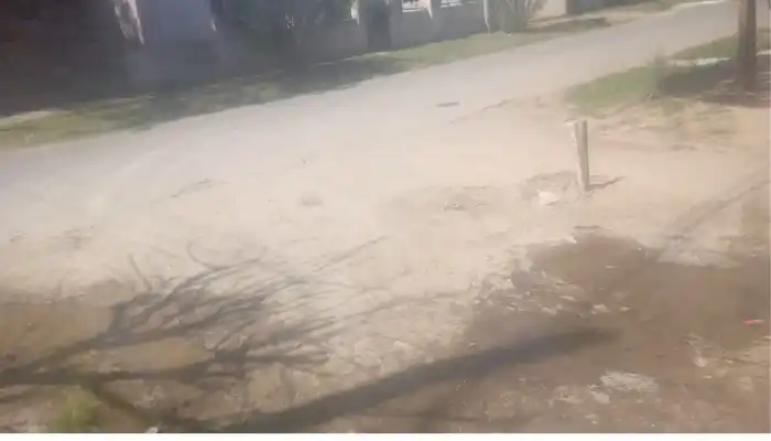 Caño de agua roto en la esquina de un jardín