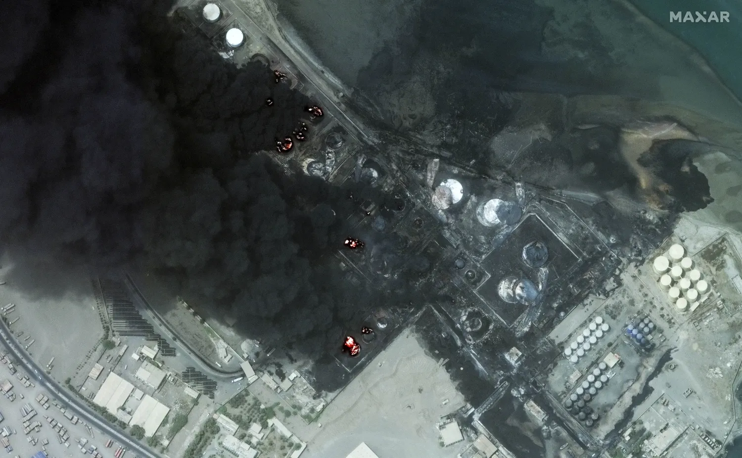 This satellite image provided by Maxar Technologies shows a close view of burning oil tanks in Hodeidah, Yemen