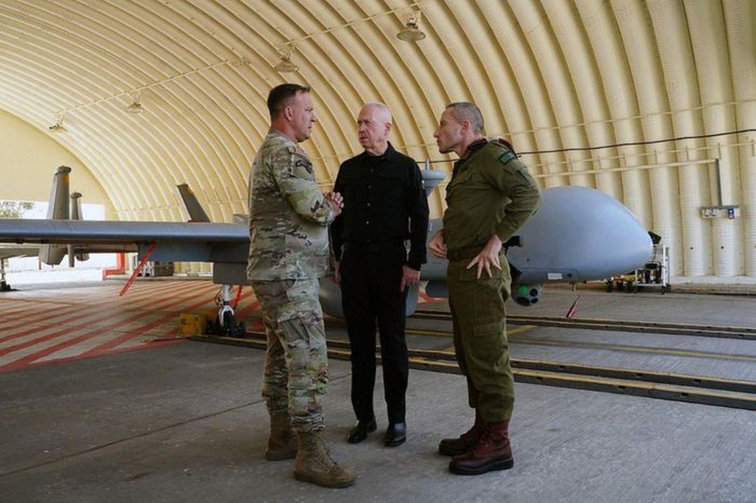 Israeli Defense Minister Yoav Gallant, in black, meeting with Army Gen. Erik Kurilla, head of U.S. Central Command, at an air base in Israel.