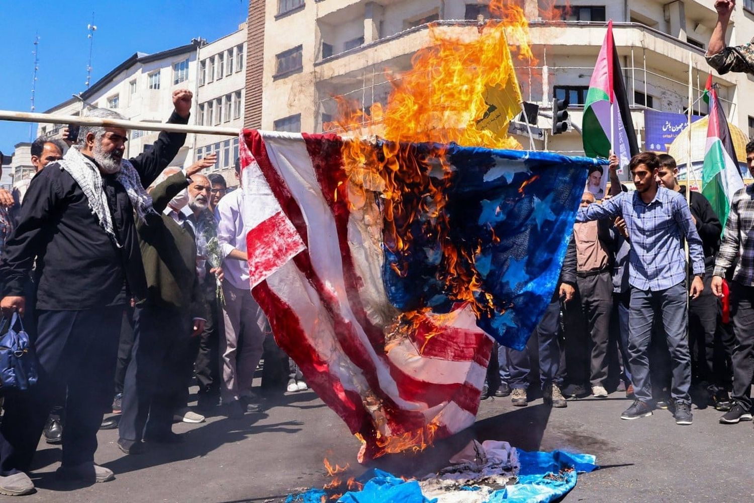 Demonstrators burn US and Israeli flags during the funeral for seven Islamic Revolutionary Guard Corps members killed in a strike in Syria in Tehran on Friday.