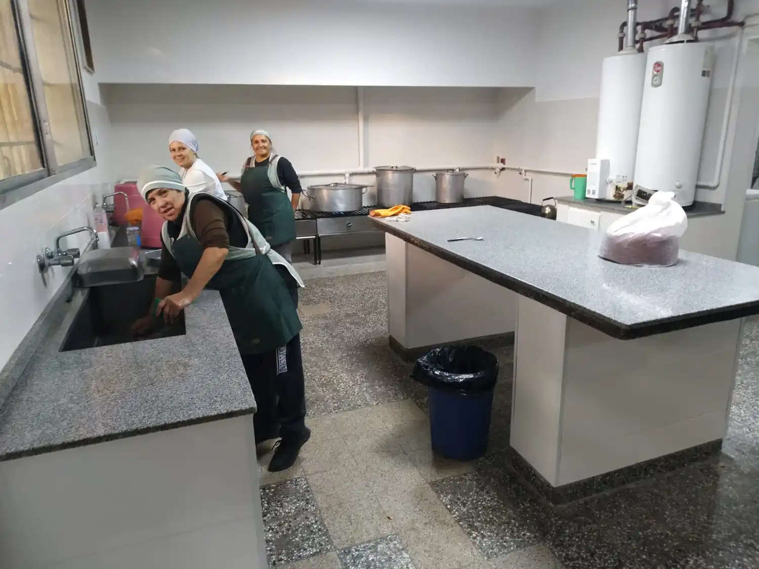 Las cocineras en plena acción disfrutando de las nuevas instalaciones.