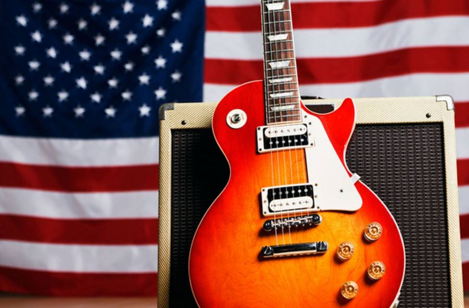 A guitar and the American flag—a symbol of the enduring spirit and diverse influences that shaped American music, from blues to rock 'n' roll.