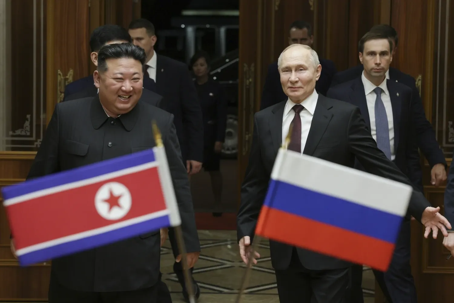 Russian President Vladimir Putin, right, and North Korea's leader Kim Jong Un smile during their meeting at the Pyongyang Sunan International Airport