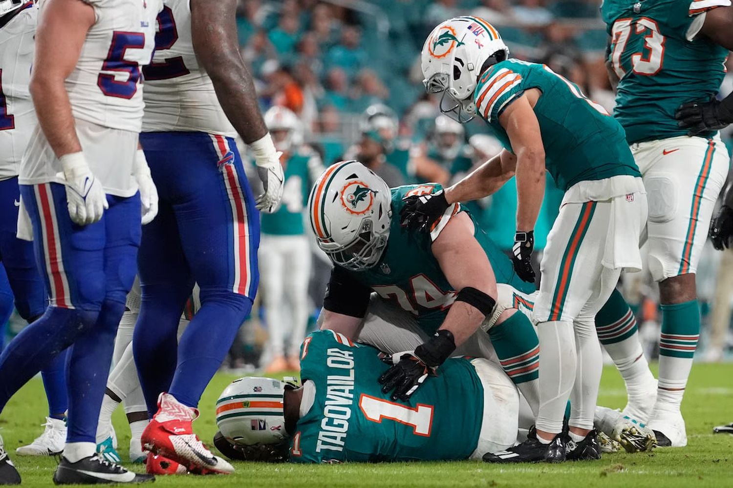 Miami Dolphins offensive tackle Liam Eichenberg sits with quarterback Tua Tagovailoa after he was concussed in a game against the Buffalo Bills