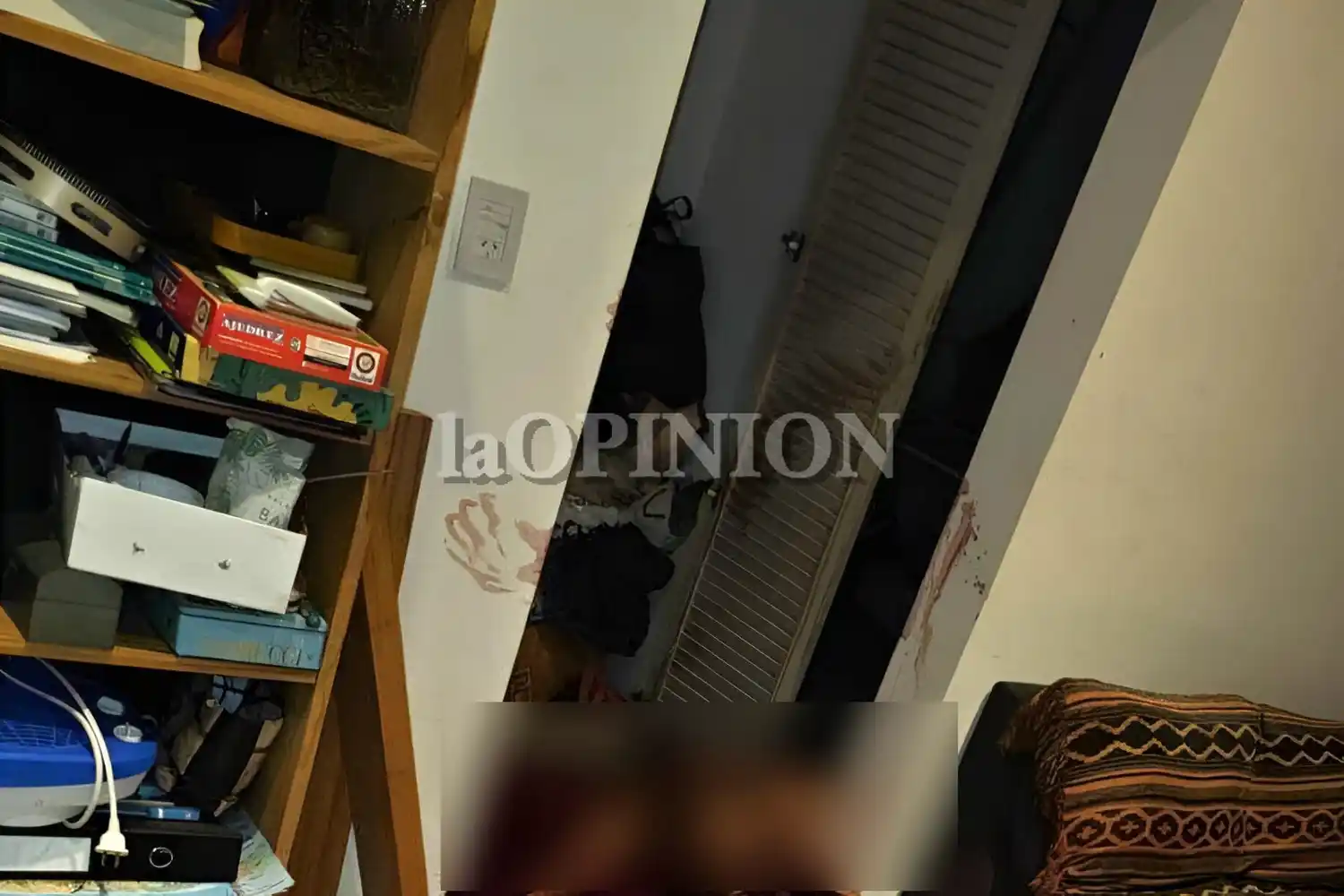 El cuerpo fue hallado boca arriba y había manchas de sangre en la pared.