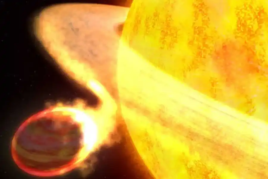 El exoplaneta, identificado como WASP-12b, siendo absorbido poco a poco por su 'Sol'.