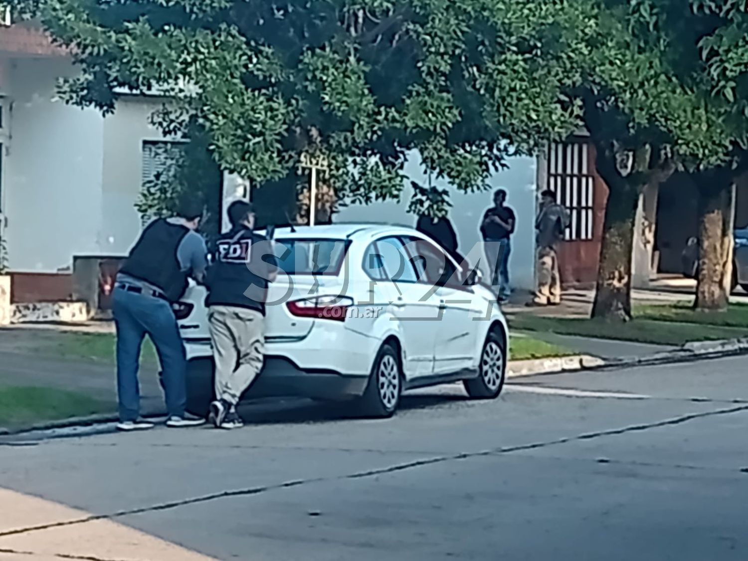 Los agentes frente a la casa en donde se registró el crimen el 18 de mayo de 2023.