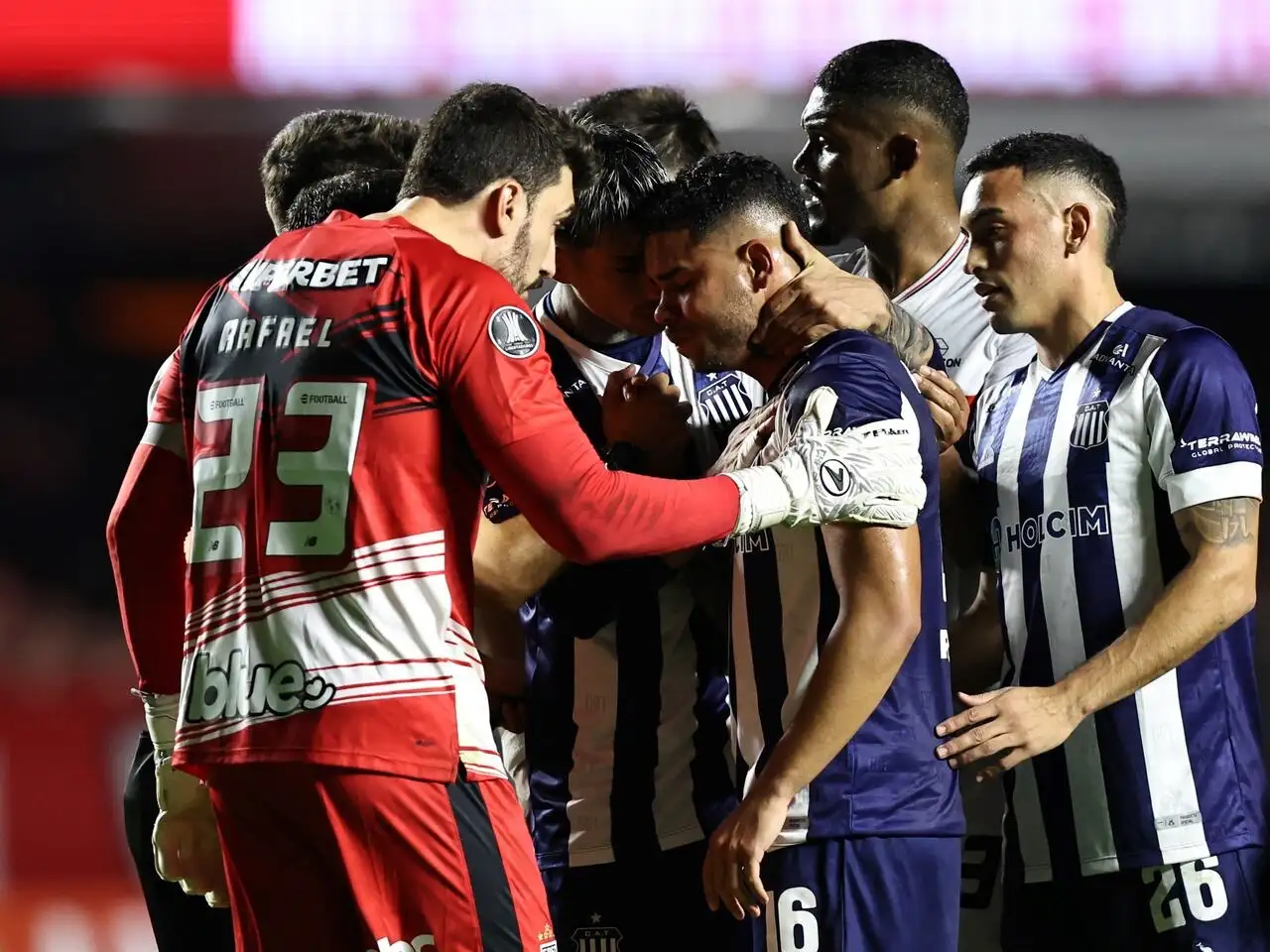 Compañeros y rivales consolando a Navarro.