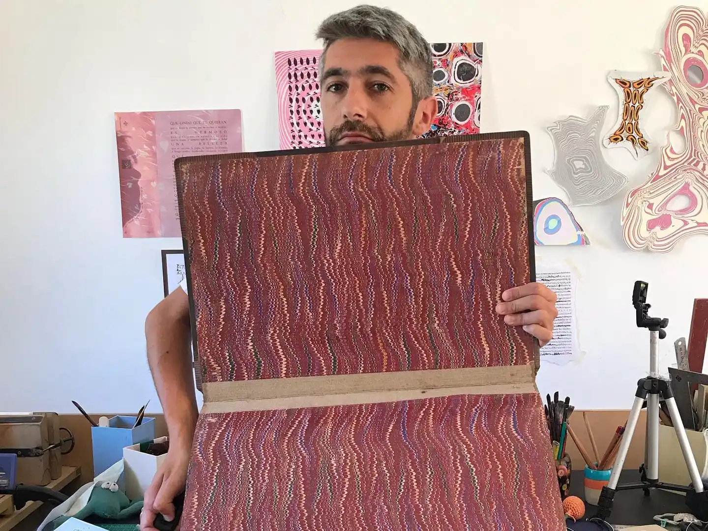 Gianotti en el interior de su taller, posando con uno de sus trabajos destacados