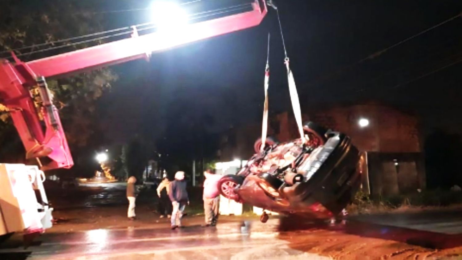 El automóvil caído en el zanjón lateral de calle Rojas es retirado por una potente grúa (Foto Carlos Guerreros)
