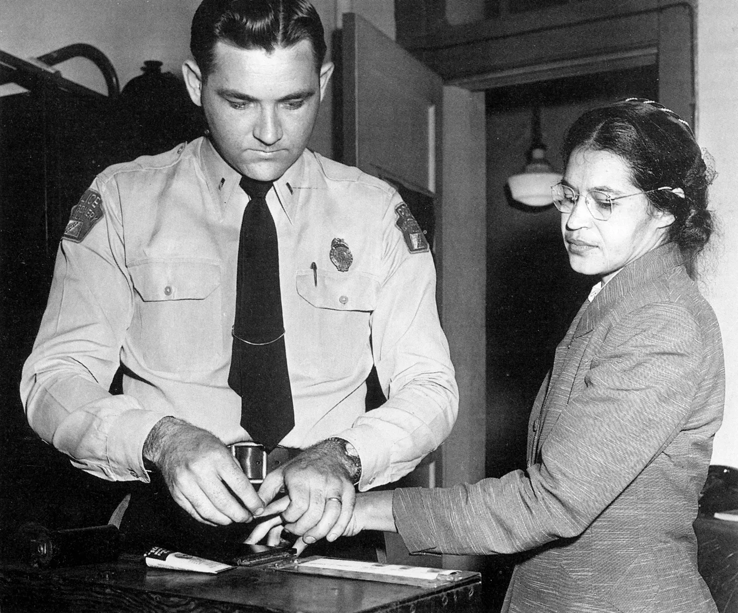 Rosa Parks' arrest photo after refusing to give up her bus seat, sparking the Montgomery Bus Boycott.