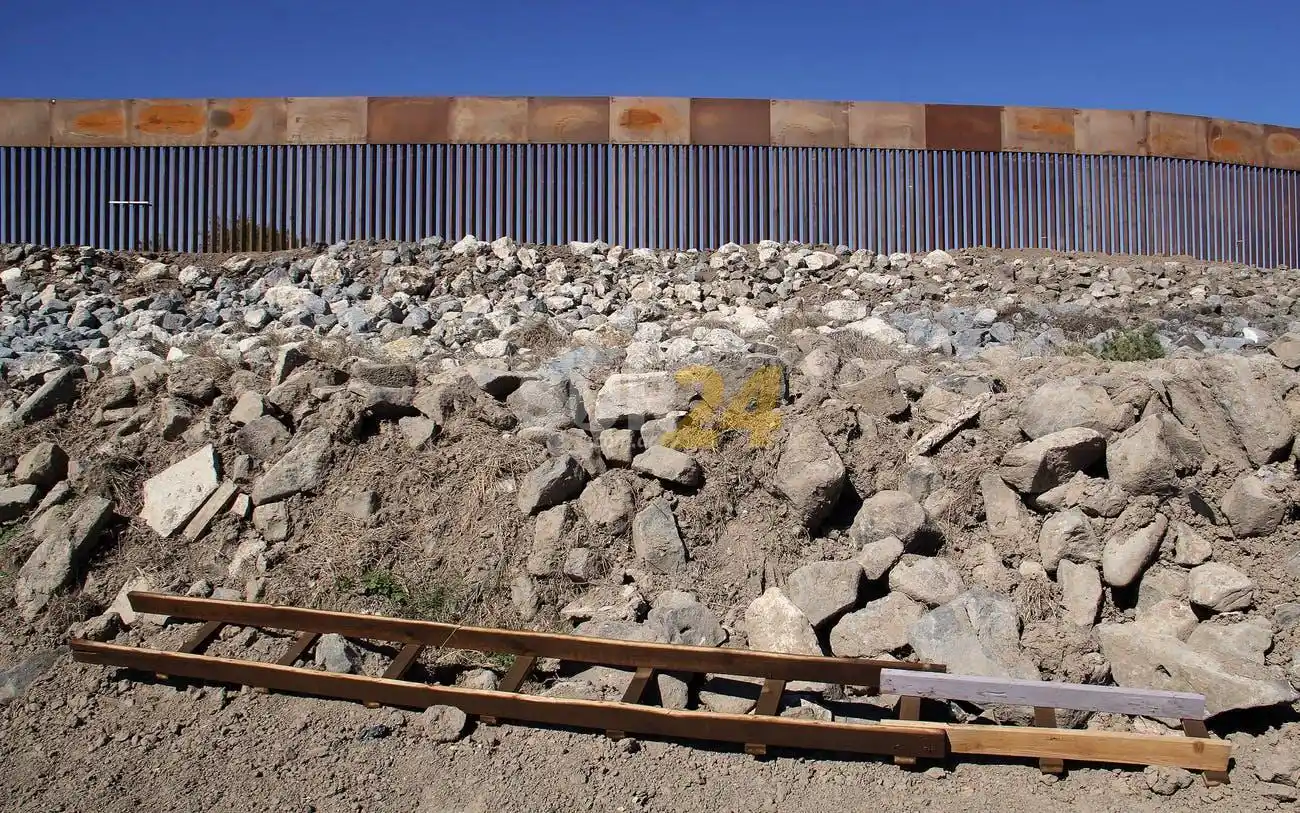 Migrantes cruzan el muro de US$ 15 mil millones con escaleras de 5 dólares