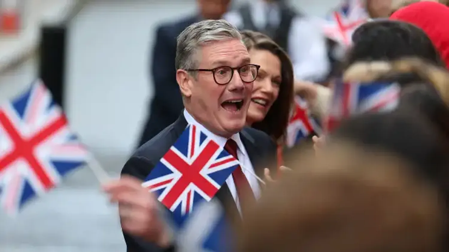 British Prime Minister Keir Starmer and his wife Victoria Starmer react as they greet Labour campaigners and activists at Number 10 Downing Street