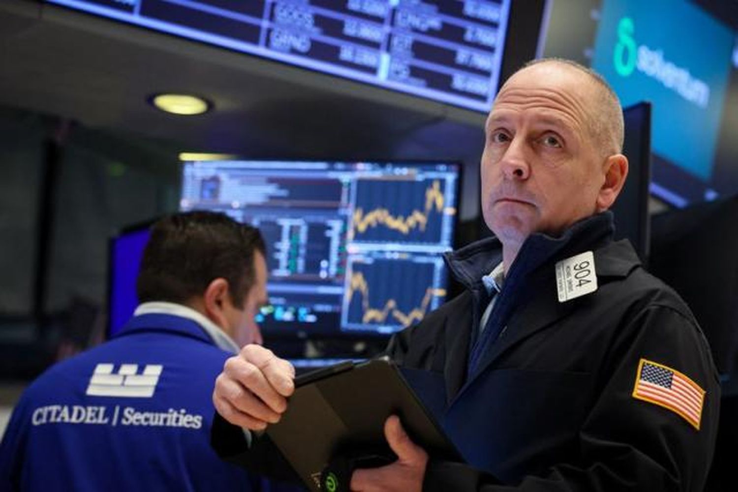 Traders work on the floor of the NYSE in New York