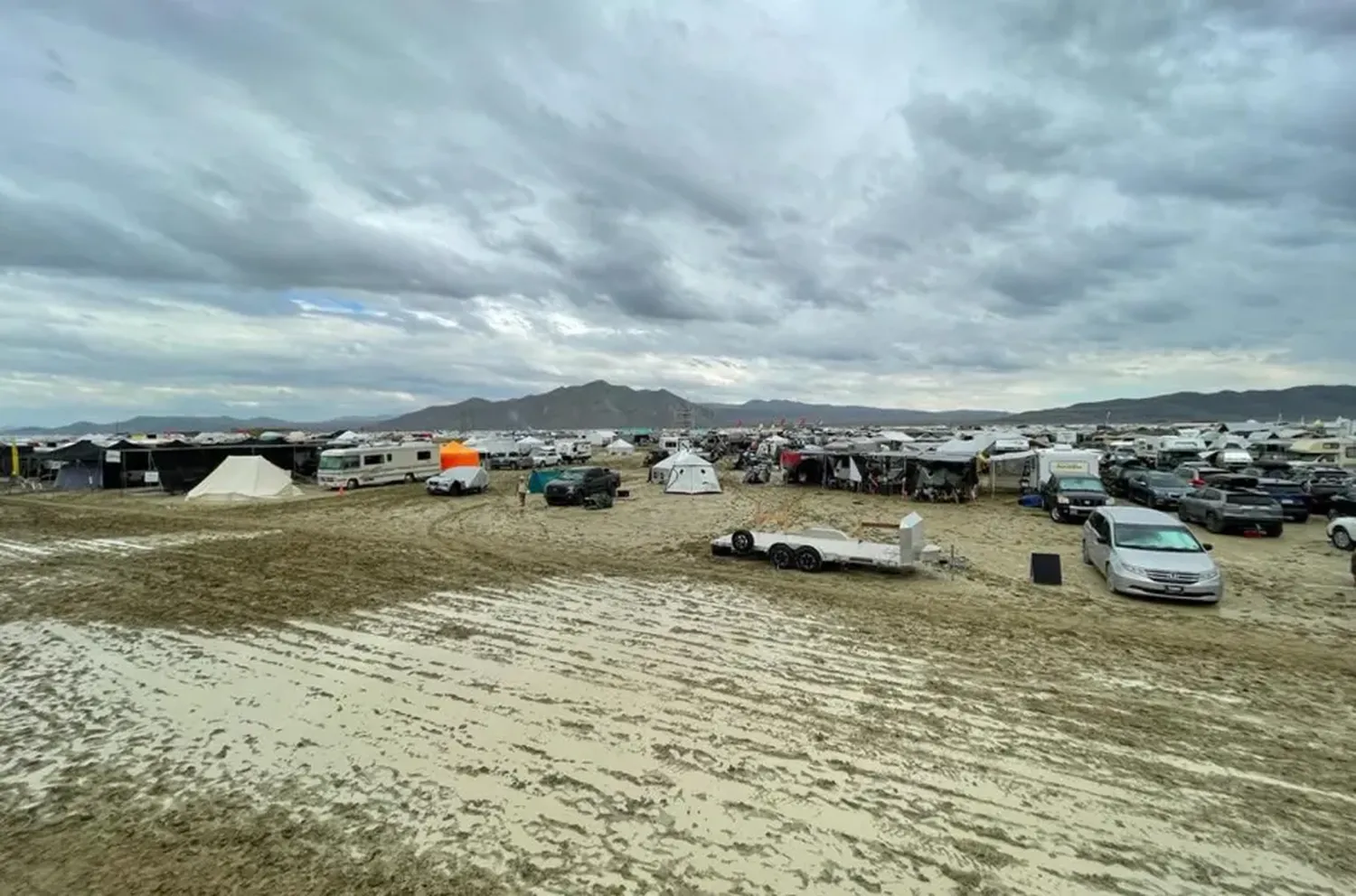 Camps are set on a muddy desert plain on Sept. 2, 2023, after heavy rains turned the annual Burning Man festival site in Nevada's Black Rock desert into a mud pit.