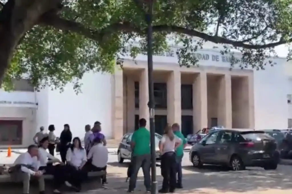 Los empleados esperan afuera del municipio mientras la Brigada de Explosivos revisaba el lugar