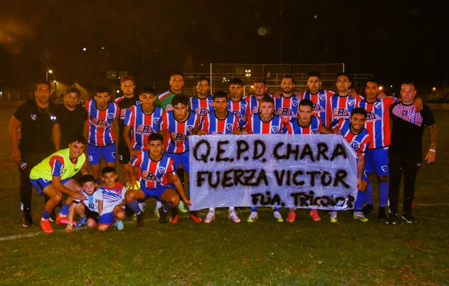 Plantel y cuerpo técnico posando con la bandera en homenaje a Gerardo Manccini, DT del "Tricolor" hasta hace algunas fechas,y que dejó su cargo por la enfermedad que lo llevó a su fallecimiento este lunes al mediodía. Foto: Lorena Canaveccio