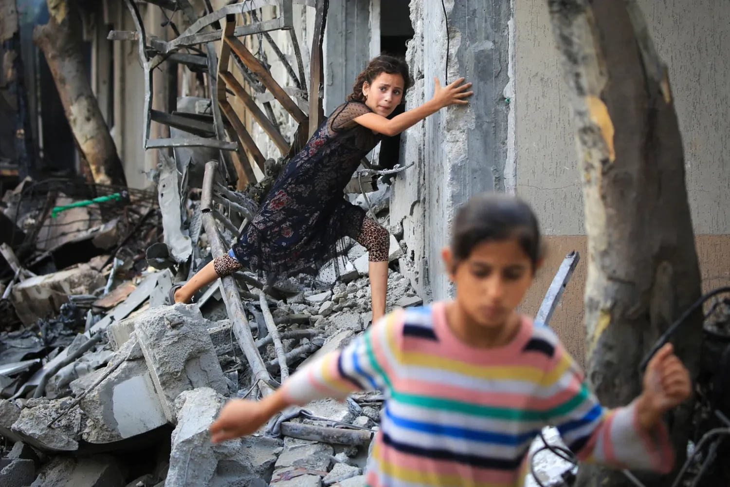 Children climb over debris a day after an operation by Israeli special forces in the Nuseirat camp, in the central Gaza Strip on Sunday.