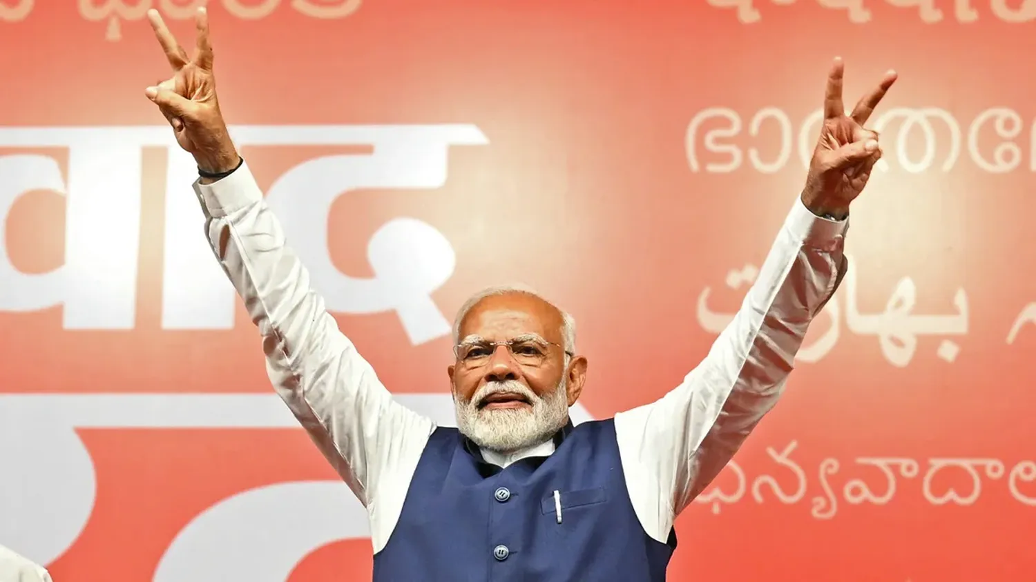 India's Prime Minister Narendra Modi flashes victory sign at the Bharatiya Janata Party